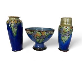 Two similar Royal Doulton vases and a similar footed fruit bowl