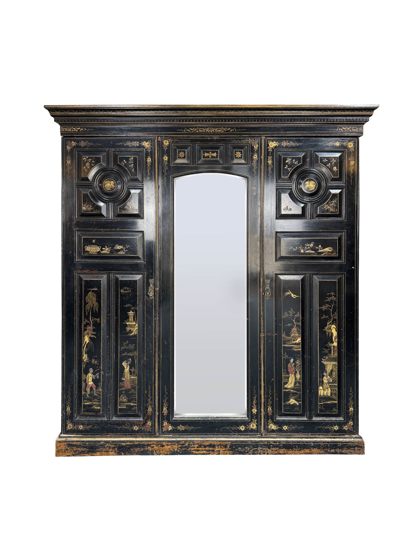 A Victorian Aesthetic period ebonised and decorated triple wardrobe