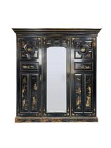 A Victorian Aesthetic period ebonised and decorated triple wardrobe