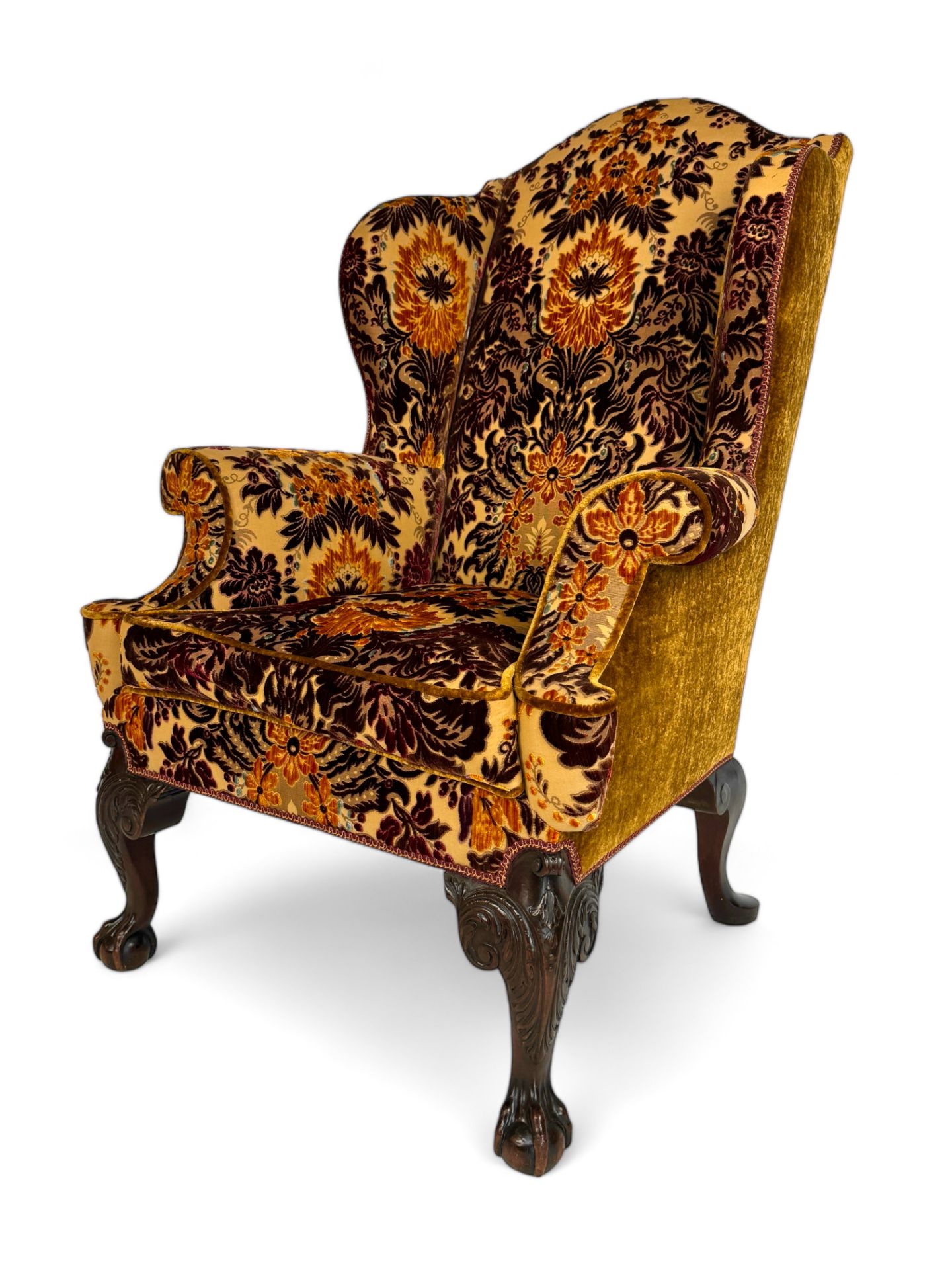 A George II style carved mahogany wing arm chair