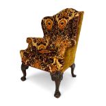 A George II style carved mahogany wing arm chair