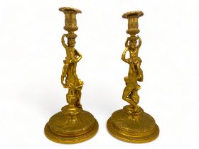 A pair of large 19th century French ormolu candlesticks in the manner of Corneille Van Cleve (French