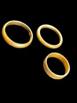 Three gold wedding bands, all 22ct, Birmingham hallmarks