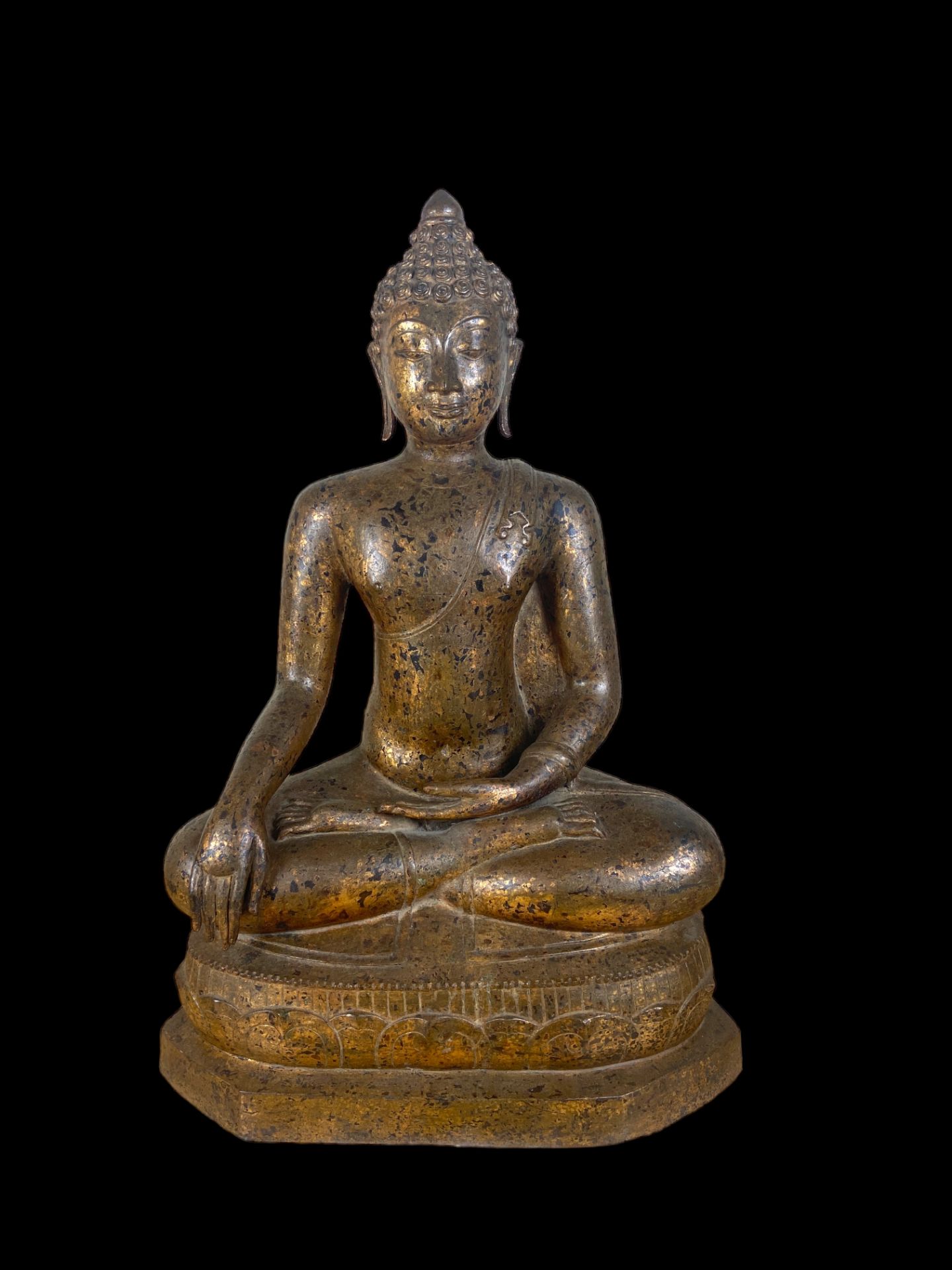 An 18th century Thai gilt bronze seated figure of Buddha Shakyamuni