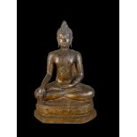 An 18th century Thai gilt bronze seated figure of Buddha Shakyamuni