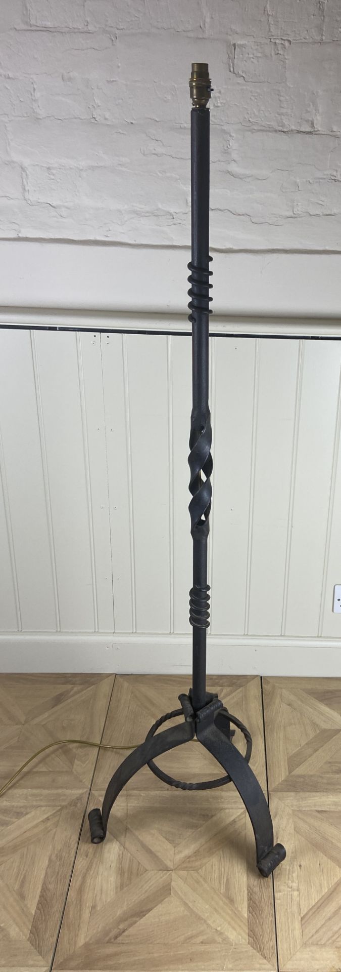 A wrought iron standard lamp