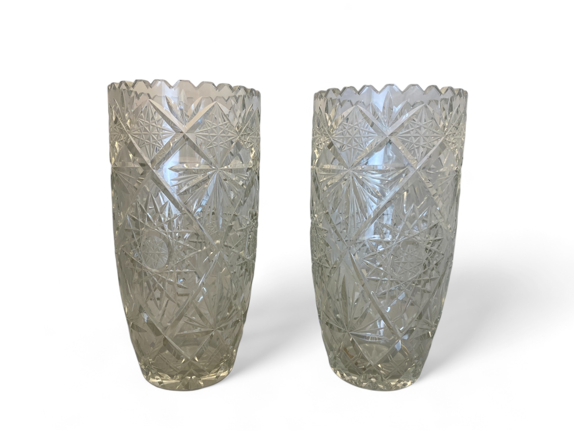 A pair of heavy cut glass flower vases