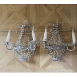 A pair of contemporary silvered metal, beaded and cut glass twin light wall-lights