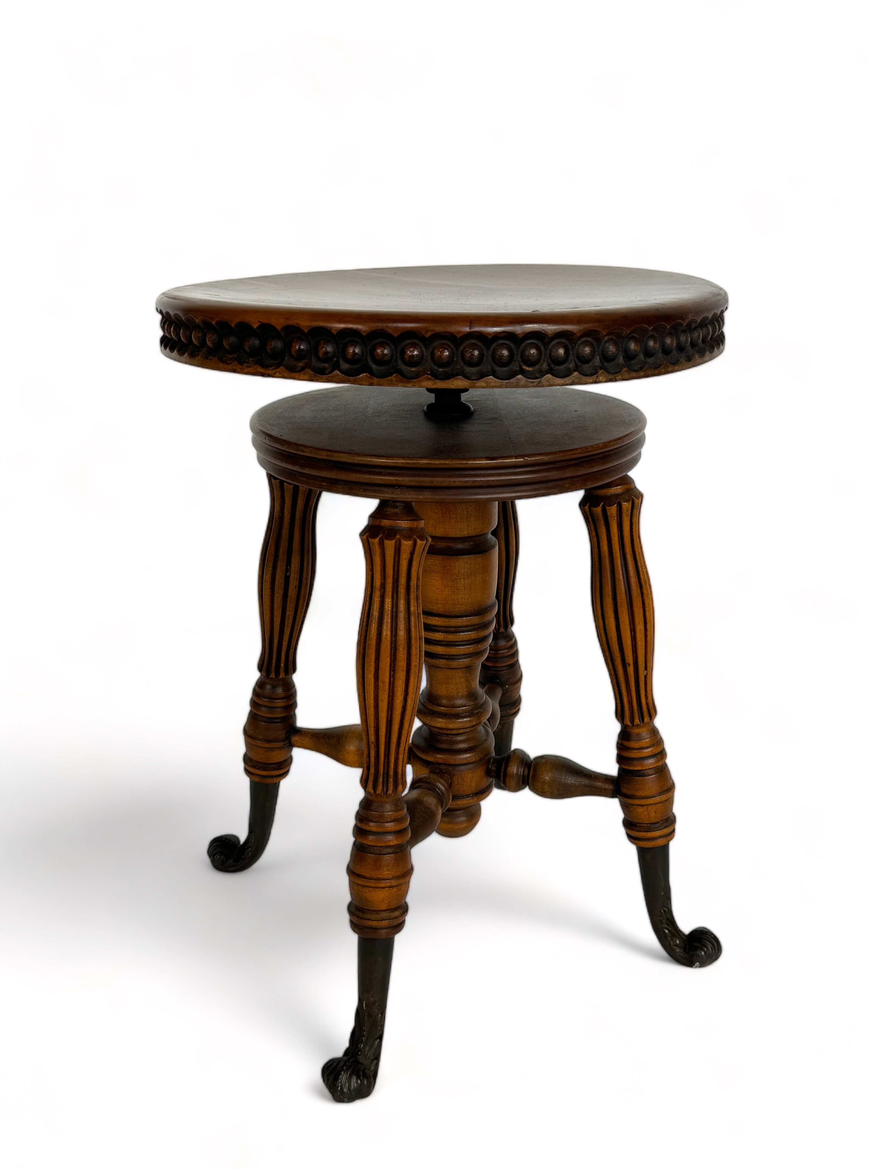 A late 19th century American beechwood circular revolving piano stool by Tonk of New York & Chicago