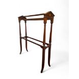 An Edwardian mahogany and marquetry towel rail The gabled ends with marquetry paterae on tapering