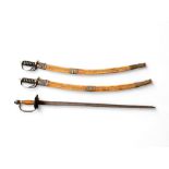 A pair of mid 20th century Indian scimitar swords together with a European backsword