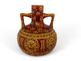 A Burmantofts faience red and yellow glazed twin handled vase