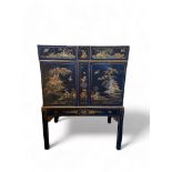 An early 20th century black japanned cabinet attributed to Hille