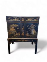 An early 20th century black japanned cabinet attributed to Hille