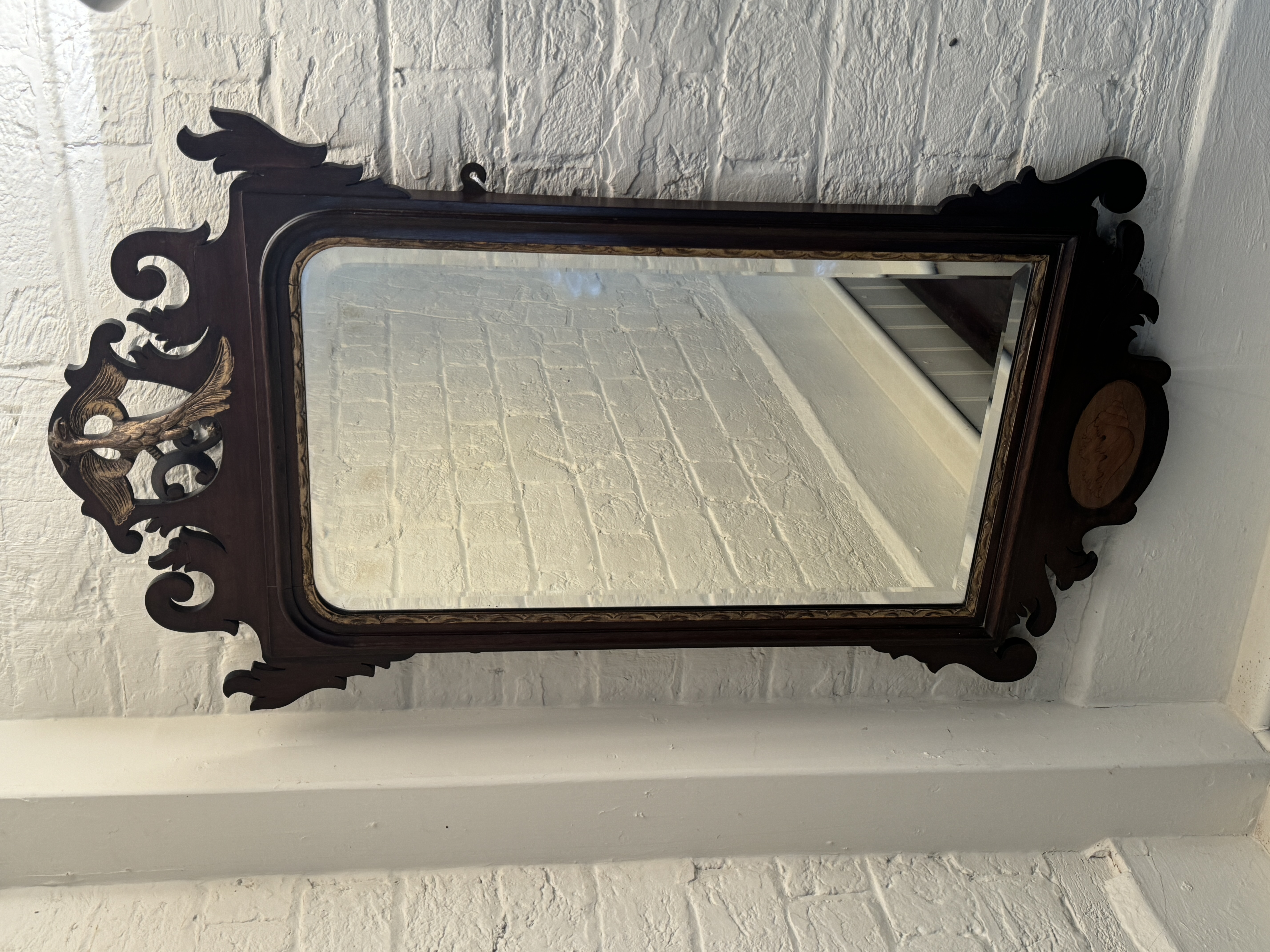 A 19th century mahogany and parcel gilt fret carved mirror in the George II style