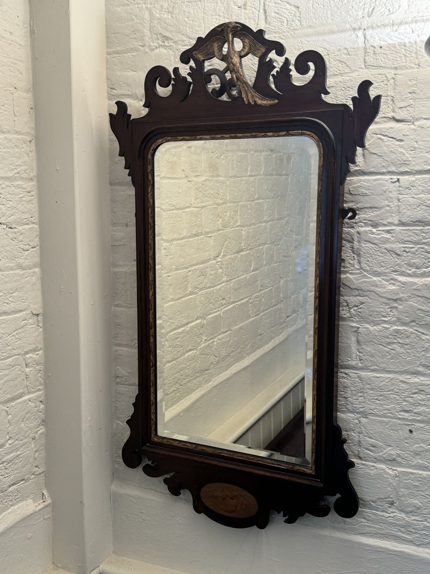 A 19th century mahogany and parcel gilt fret carved mirror in the George II style