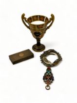 A Victorian champlevé enamel hand mirror, a silver snuff box and a Crown Derby urn