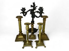 A 19th century French patinated bronze rococo style three branch candelabra, two pairs of brass cand