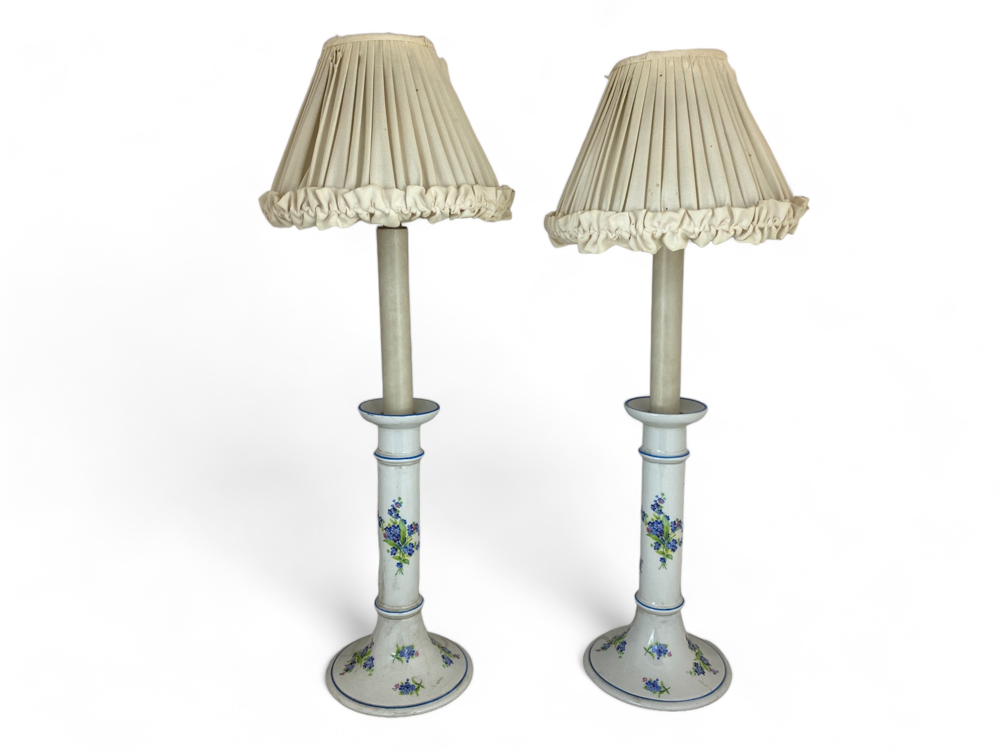 A pair of white porcelain blue floral decorated candlestick table lamps