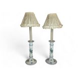 A pair of white porcelain blue floral decorated candlestick table lamps