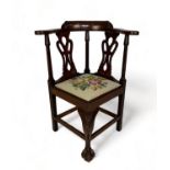 A late 19th century carved mahogany child's corner chair in the George II style