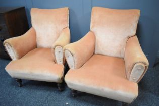 A pair of Howard style armchairs, upholstered in pink velour, with square tapered oak feet raised on