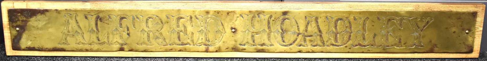 A large brass "Alfred Hoadley" hand engraved shop sign, reputedly from Hoadleys Limited of Burgess