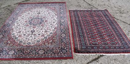 A Royal Classic rug made from New Zealand wool, red ground with floral decoration, 170cm by 246cm,