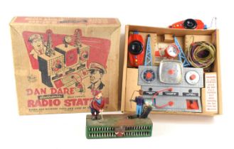 A vintage Dan Dare radio station in the original box together with a cast iron golfing coin bank.