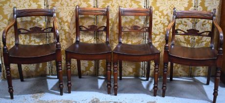 A set of four William IV mahogany dining chairs, with bentwood seat, turned legs and shaped back.