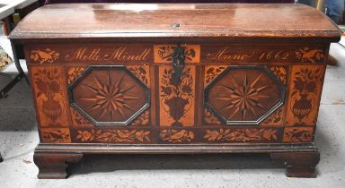 An 18th century oak domed topped chest of large proportions, with later marquetry inlaid decoration,