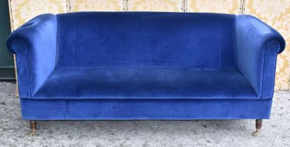 A pair of country house style three seater sofas with scroll arms, upholstered in navy blue