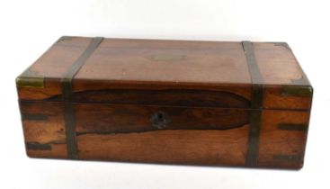 A Victorian brass bound rosewood writing box, the hinged lid enclosing interior with secret