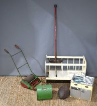 A vintage Webb children's lawnmower together with a wooden dolls cot, a Kelo Pogo stick, childrens