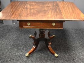 A Regency mahogany Pembroke table, raised on four fluted uprights on a quadripartite base which