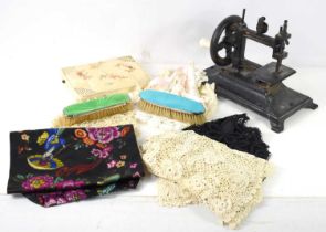 A collection of bobbin and other lace collars and miscellanea, together with a vintage cast iron