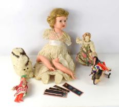 A vintage doll together with a cuddly toy with rabbit fur, a wind up moving doll and other items.