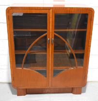 A 1920s mahogany twin door glass display cabinet, reputedly made by Henry Simpson Dellow, cabinet