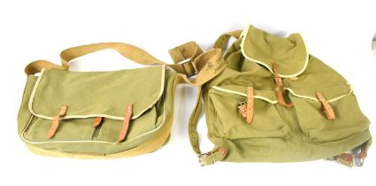 Two vintage canvas bags, one back pack, the other of satchel form, with tan leather straps.