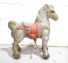 A vintage Mobo ride on toy horse, with residual paint work.