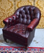 A 20th century ox blood red leather Chesterfield style armchair.