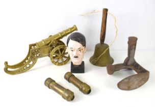 A brass cannon together with a bronze hand bell, Hitler bust and two pieces of Trench Art.
