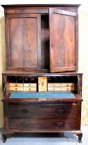 A 19th century secretaire bookcase, the top section having two panelled flame mahogany drawers