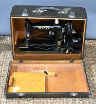 A vintage Singer sewing machine, circa 1950, with later replaced electric motor and original