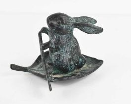 A 20th century green patinated bronzed metal rabbit paddling on a leaf, 7.5cm high.