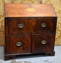 A 19th century mahogany bureau having two large drawers below a fall front opening to reveal a