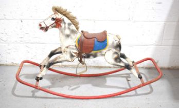 A vintage Triang "Foxhunter" childs rocking horse with painted decoration and leather saddle.