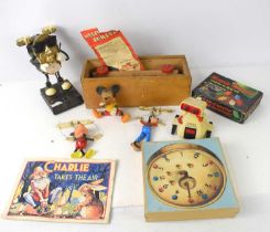 A vintage Mickey Mouse string puppet together with a Goofy string puppet, a Mickey Mouse figure,