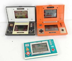 A group of three Nintendo hand held Game and Watch consoles, comprising Donkey Kong Multiscreen,