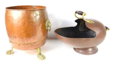A 19th century copper and brass planter with lion head handles and claw feet, 39cm high together